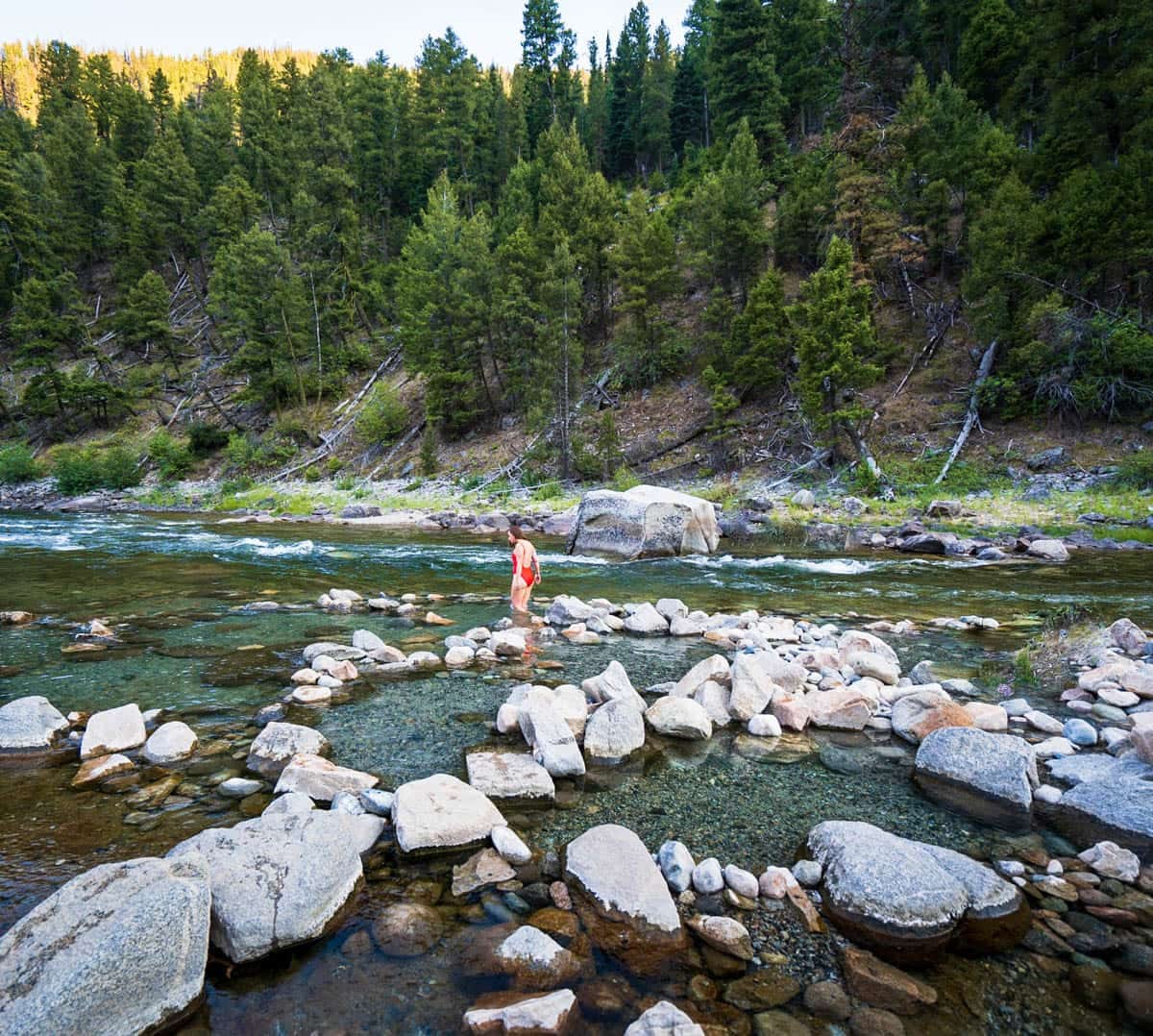 Woman walking in Sunbeam Hot Springs in Stanley, IDaho