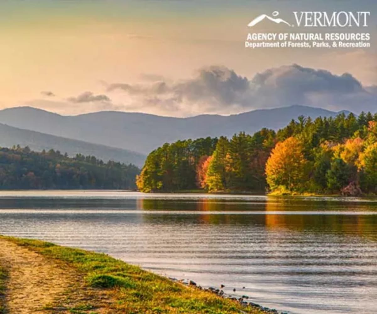 A landscape photo taken in the evening of a lake in Vermont in early fall at a Vermont State Park.